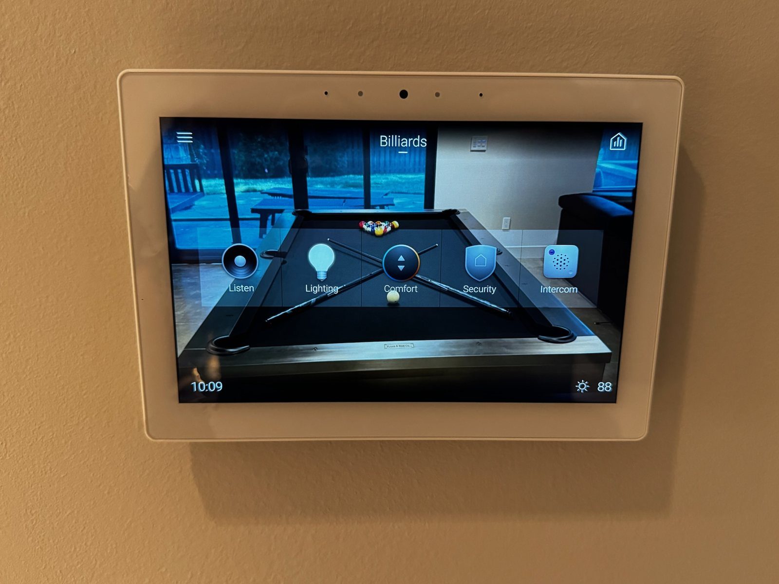 A wall touch panel for a billiards room, with buttons for Listen, Lighting, Comfort, Security and Intercom